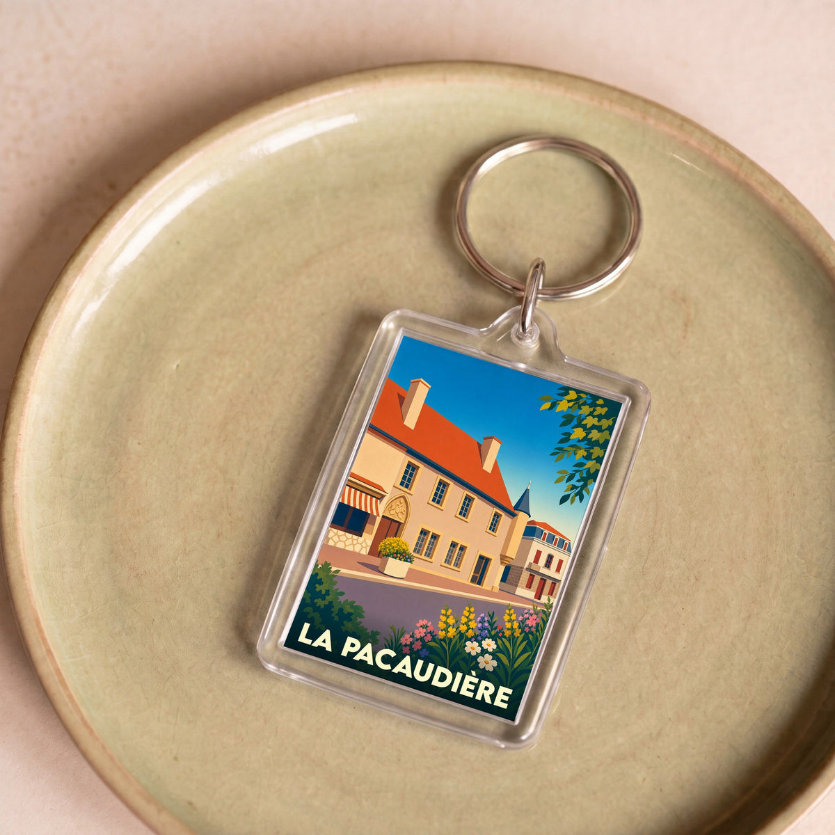 Porte-clés souvenir de la ville de La Pacaudière avec une illustration stylisée.