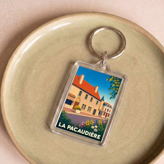 Porte-clés souvenir de la ville de La Pacaudière avec une illustration stylisée.
