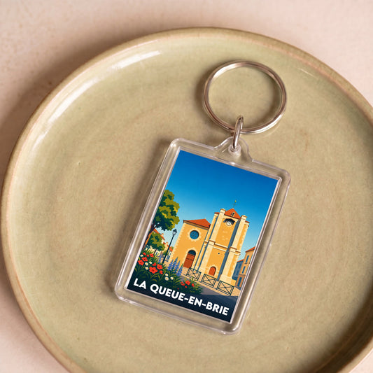 Porte-clés souvenir de la ville de La Queue-en-Brie avec une illustration stylisée.