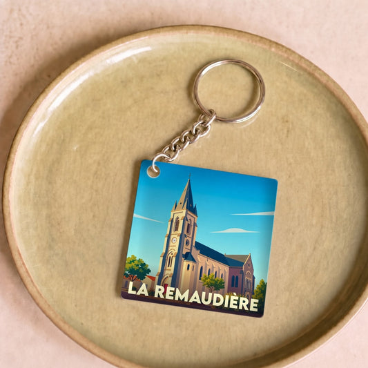 Porte-clés souvenir de la ville de La Remaudière avec une illustration stylisée de son église.