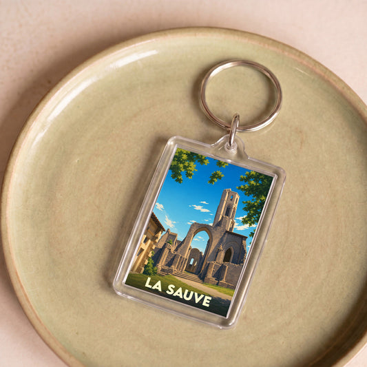 Porte-clés souvenir de la ville de La Sauve avec une illustration stylisée de son abbaye.