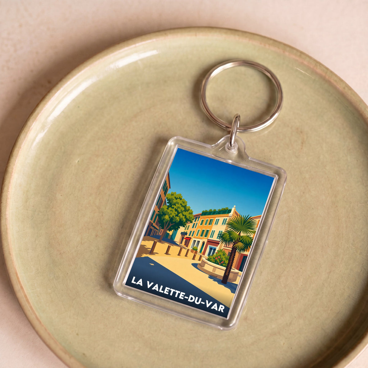 Porte-clés souvenir de la ville de La Valette-du-Var avec une illustration stylisée et colorée.