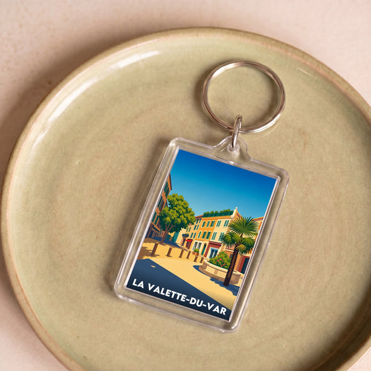 Porte-clés souvenir de la ville de La Valette-du-Var avec une illustration stylisée et colorée.