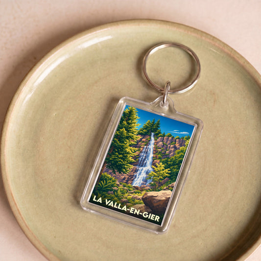 Porte-clés souvenir de la ville de La Valla-en-Gier avec une illustration stylisée d'une cascade.