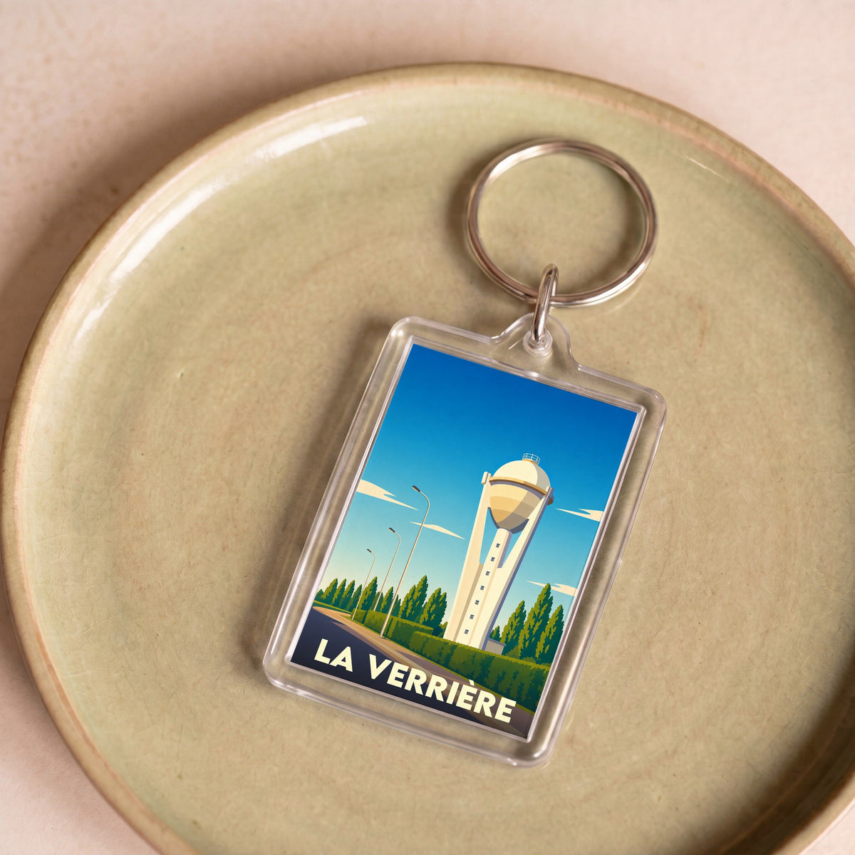 Porte-clés souvenir de la ville de La Verrière avec une illustration stylisée de son château d'eau.