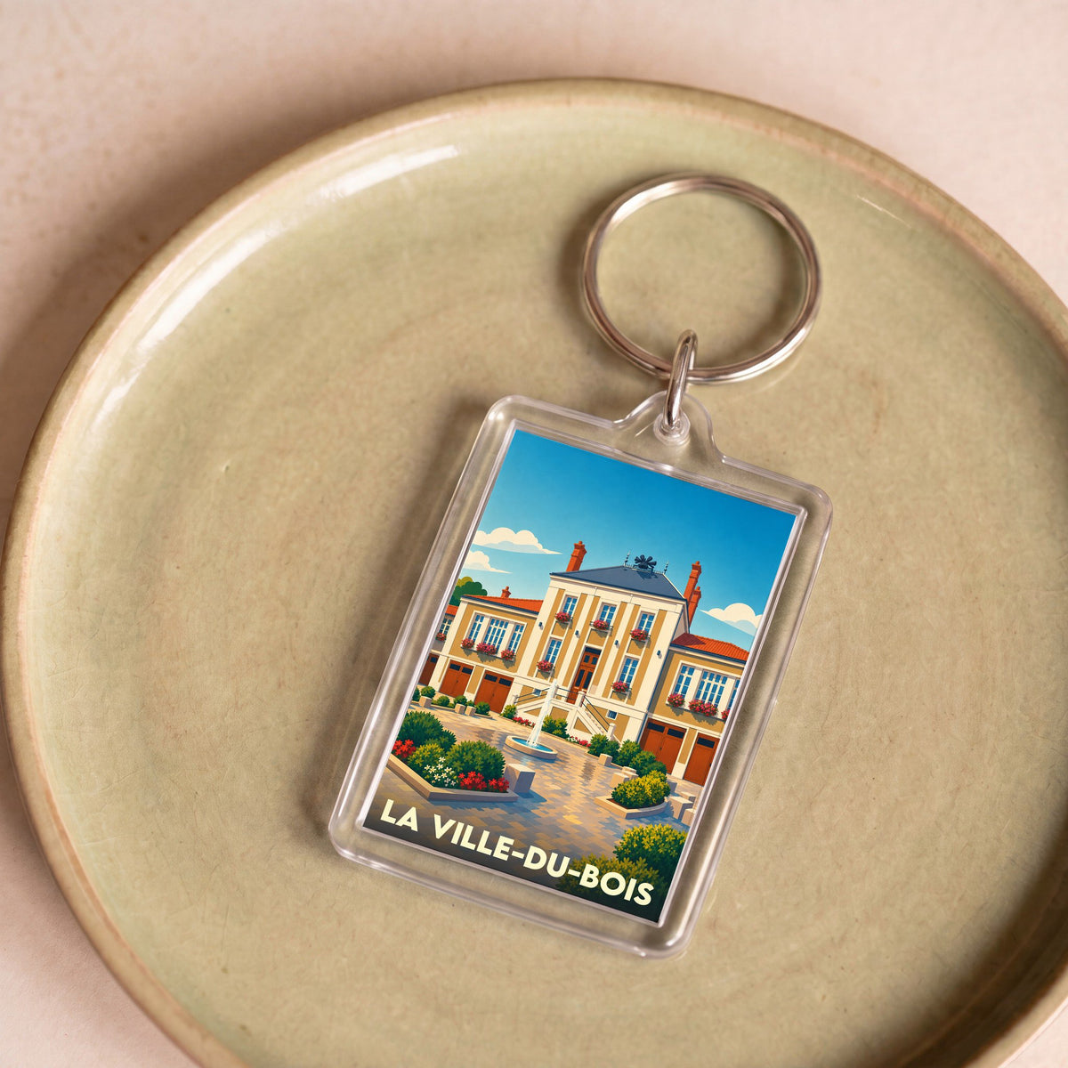 Porte-clés souvenir de la ville de La Ville-du-Bois avec une illustration stylisée de sa mairie.