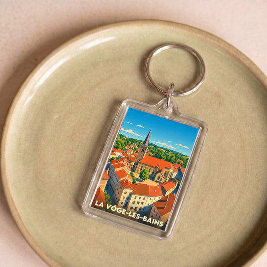 Porte-clés souvenir de la ville de La Vôge-les-Bains avec une illustration stylisée.