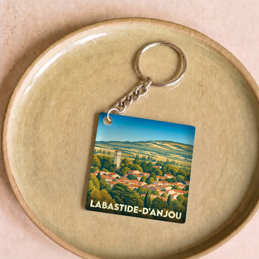 Porte-clés souvenir de la ville de Labastide-d'Anjou avec une illustration stylisée.