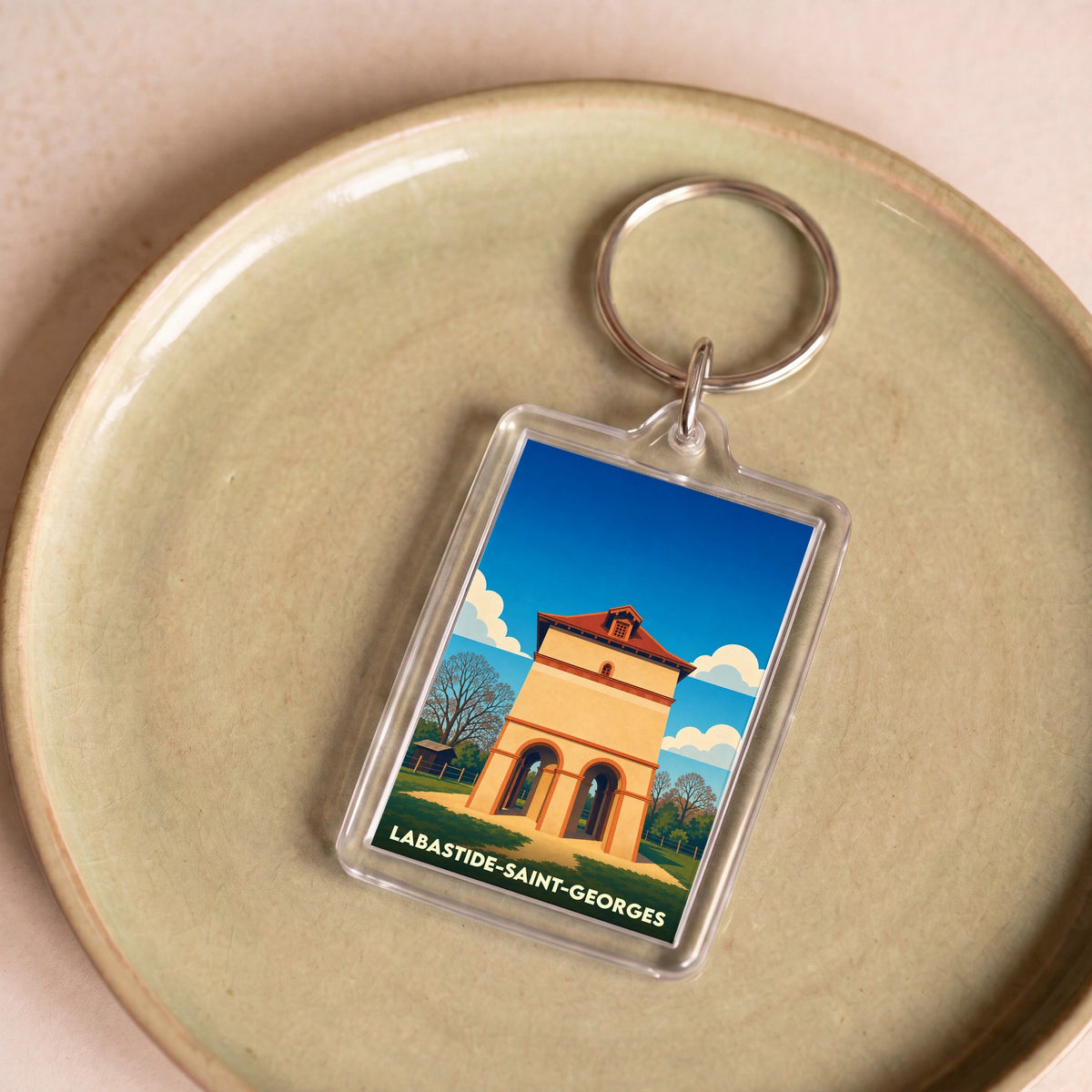 Porte-clés souvenir de la ville de Labastide-Saint-Georges avec une illustration stylisée.