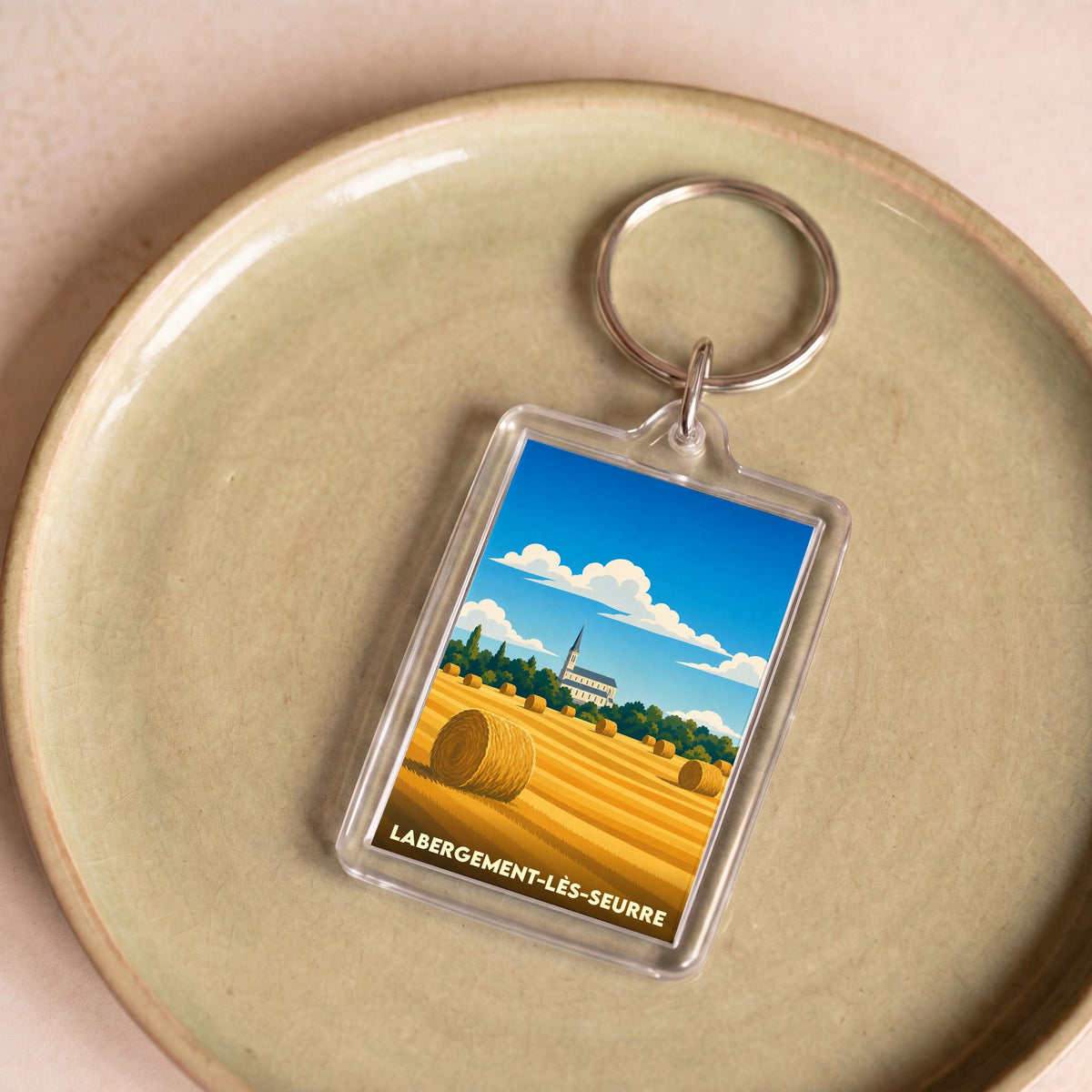 Porte-clés souvenir de la ville de Labergement-lès-Seurre avec une illustration stylisée d'un champ de blé.