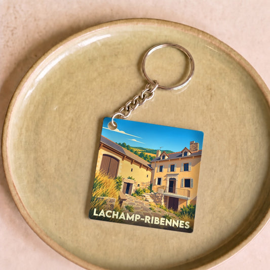 Porte-clés souvenir de la ville de Lachamp-Ribennes avec une illustration stylisée.