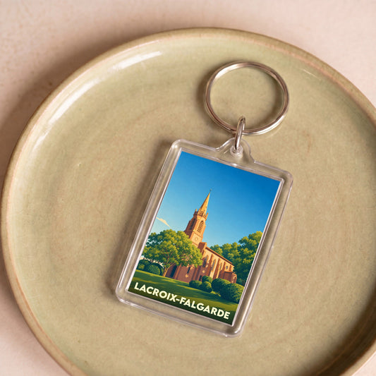 Porte-clés souvenir de la ville de Lacroix-Falgarde avec une illustration stylisée de son église.