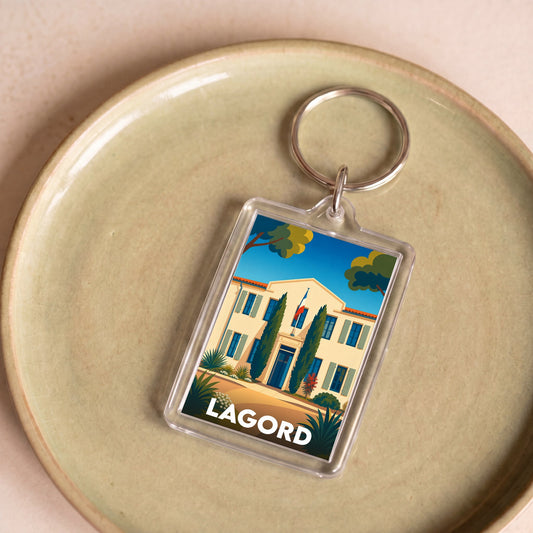 Porte-clés souvenir de la ville de Lagord avec une illustration stylisée d'une demeure traditionnelle.