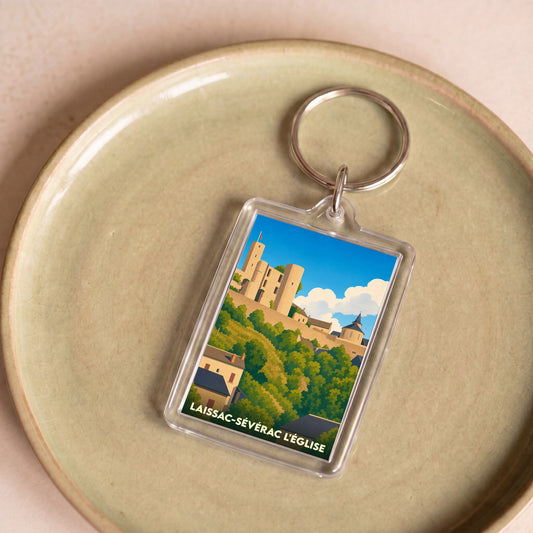 Porte-clés souvenir de la commune de Laissac-Sévérac l'Église avec une illustration stylisée de son château.