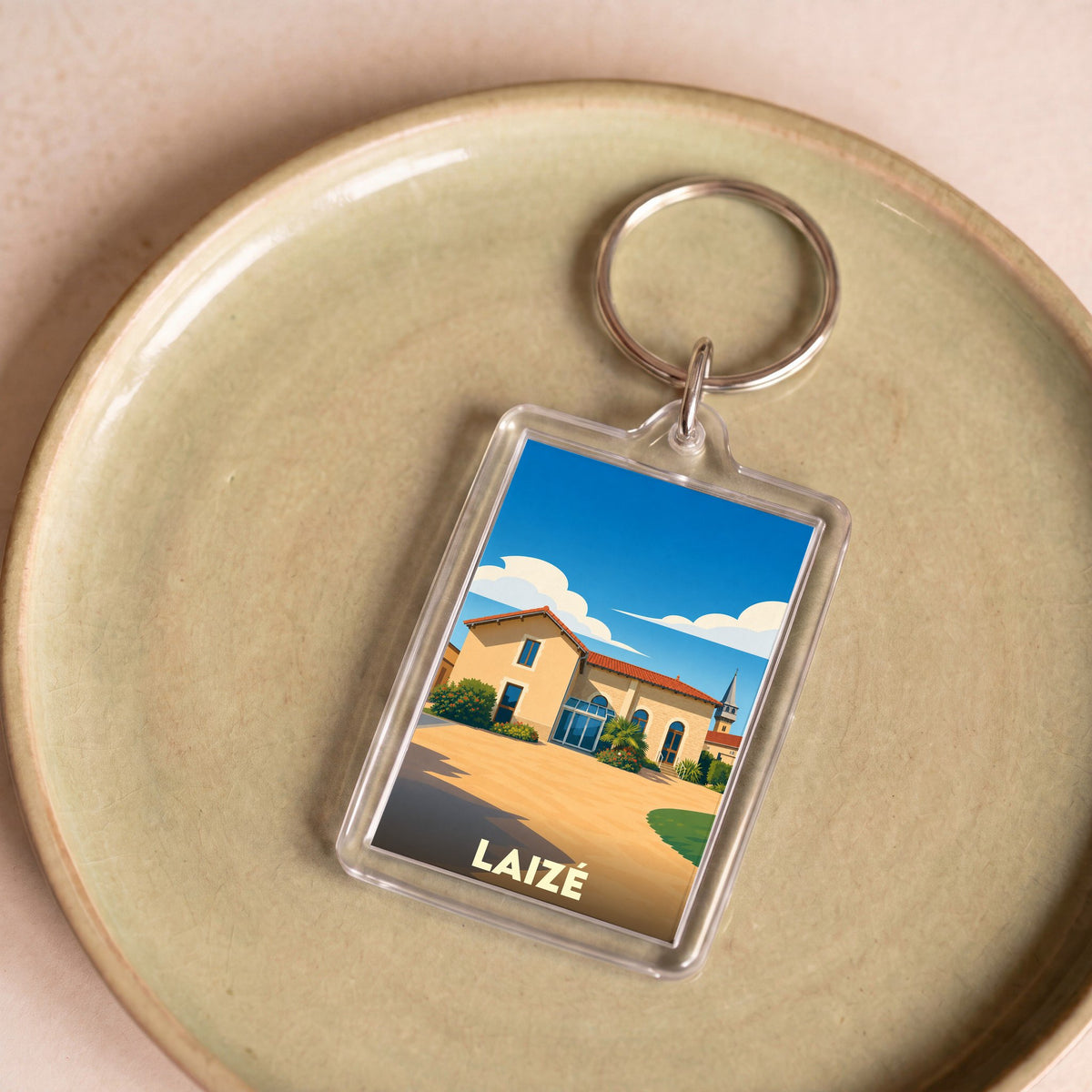 Porte-clés souvenir de la ville de Laizé avec une illustration stylisée.