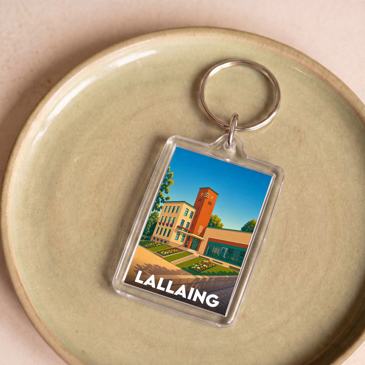 Porte-clés souvenir de la ville de Lallaing avec une illustration stylisée.