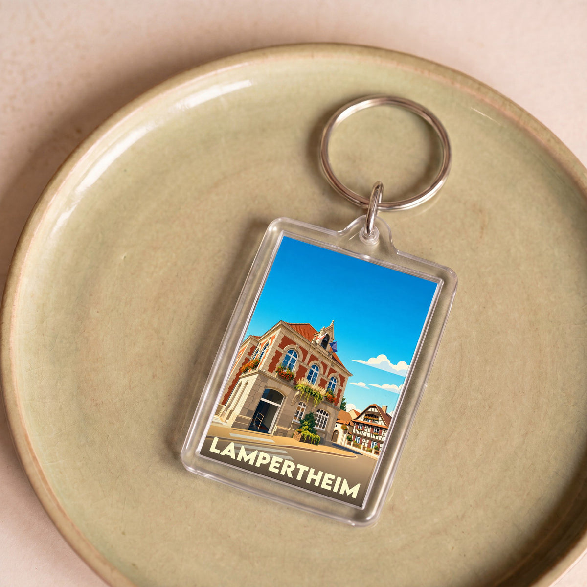 Porte-clés souvenir de la ville de Lampertheim avec une illustration stylisée.