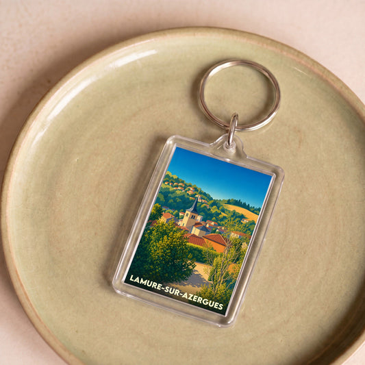 Porte-clés souvenir de la ville de Lamure-sur-Azergues avec une illustration stylisée.