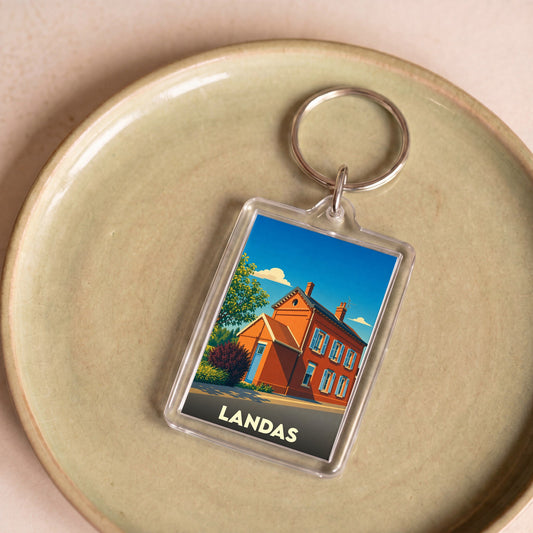Porte-clés souvenir de la ville de Landas avec une illustration stylisée d'une maison traditionnelle.