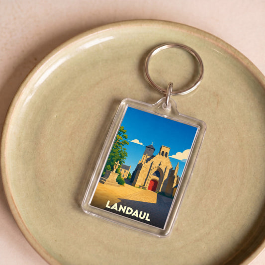 Porte-clés souvenir de la ville de Landaul avec une illustration stylisée de son église.
