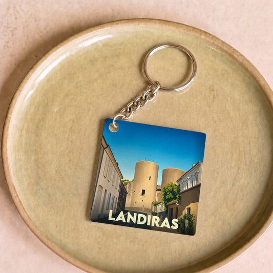 Porte-clés souvenir de la ville de Landiras avec une illustration stylisée.