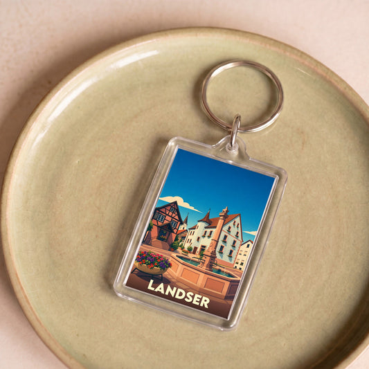 Porte-clés souvenir de la ville de Landser avec une illustration stylisée.