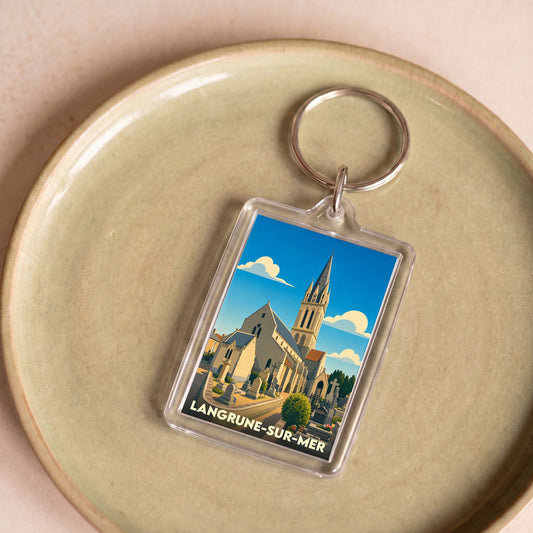 Porte-clés souvenir de la ville de Langrune-sur-Mer avec une illustration stylisée de son église.