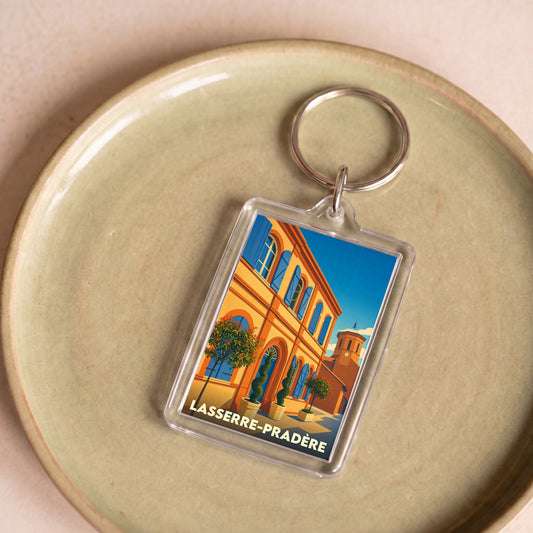 Porte-clés souvenir de la ville de Lasserre-Pradère avec une illustration colorée et stylisée.