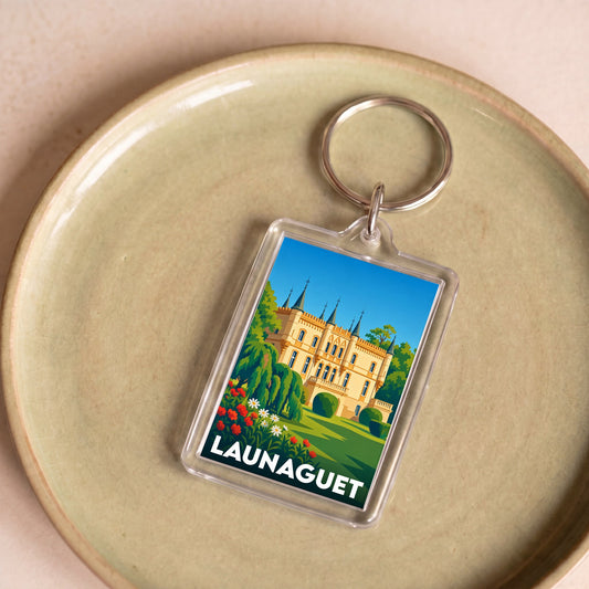 Porte-clés souvenir de la ville de Launaguet avec une illustration stylisée de son château.