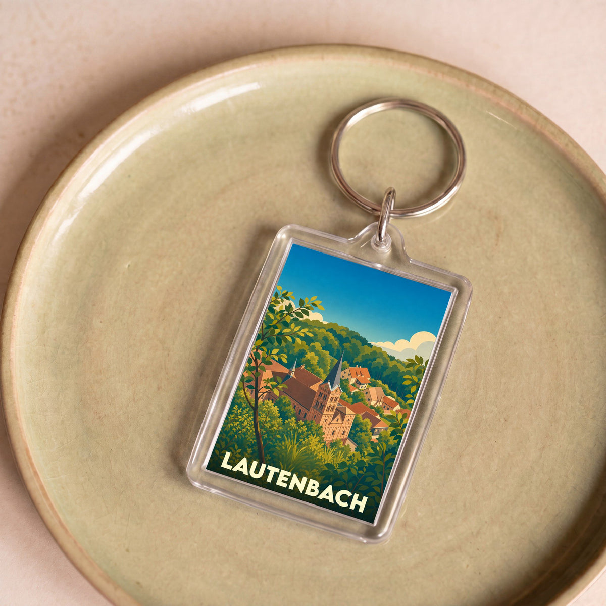 Porte-clés souvenir de la ville de Lautenbach avec une illustration stylisée.