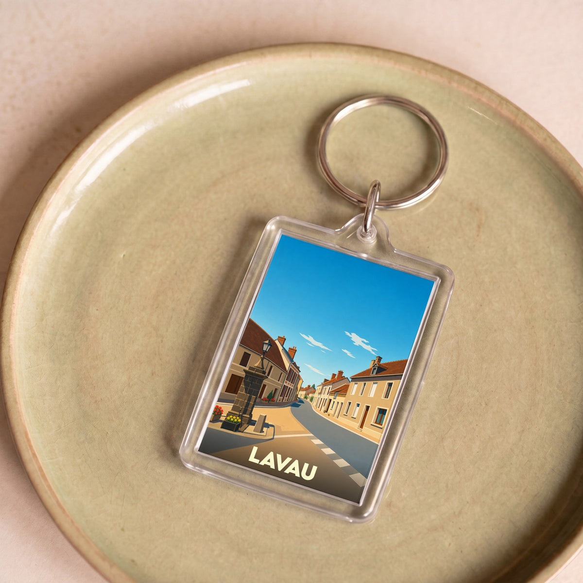 Porte-clés souvenir de la ville de Lavau avec une illustration stylisée.