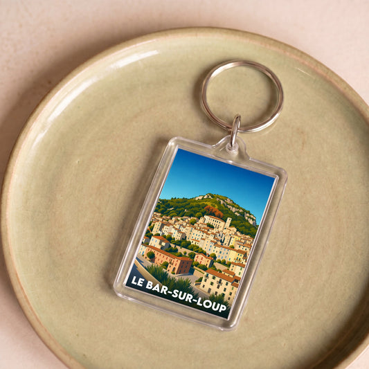 Porte-clés souvenir de la ville de Le Bar-sur-Loup avec une illustration stylisée.