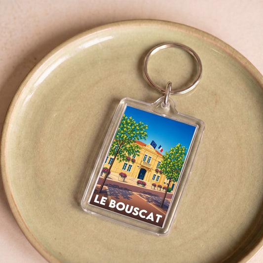 Porte-clés souvenir de la ville de Le Bouscat avec une illustration stylisée de son hôtel de ville.