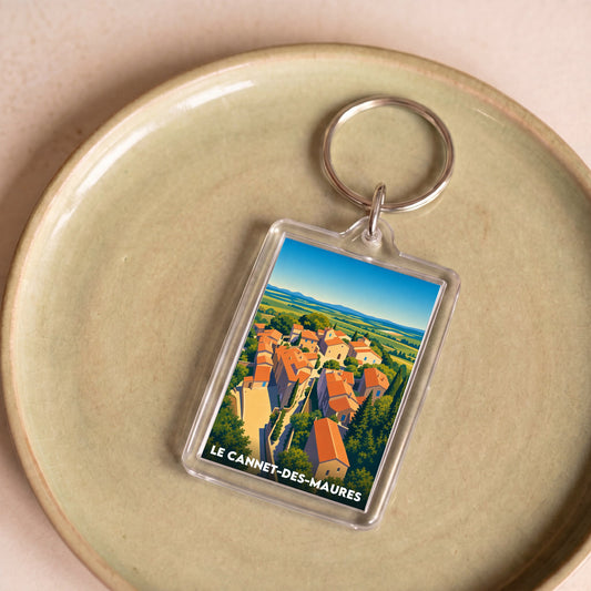 Porte-clés souvenir de la ville de Le Cannet-des-Maures avec une illustration stylisée.