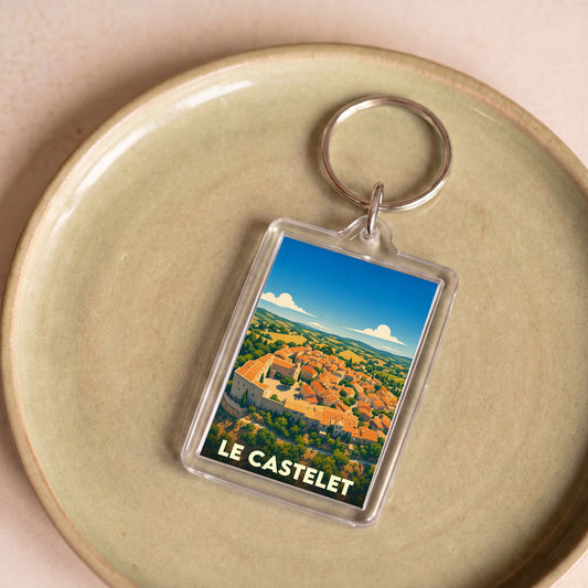 Porte-clés souvenir de la ville du Castelet avec une illustration stylisée.