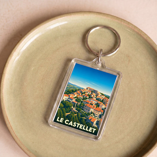 Porte-clés souvenir de la ville de Le Castellet avec une illustration stylisée.