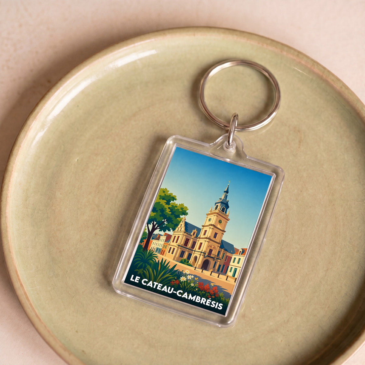 Porte-clés souvenir de la ville de Le Cateau-Cambrésis avec une illustration stylisée.