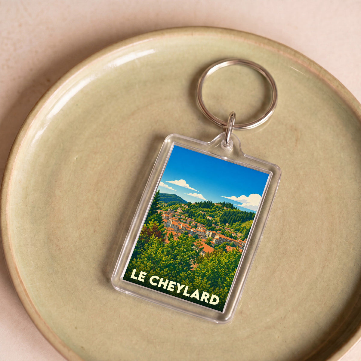 Porte-clés souvenir de la ville de Le Cheylard avec une illustration stylisée.