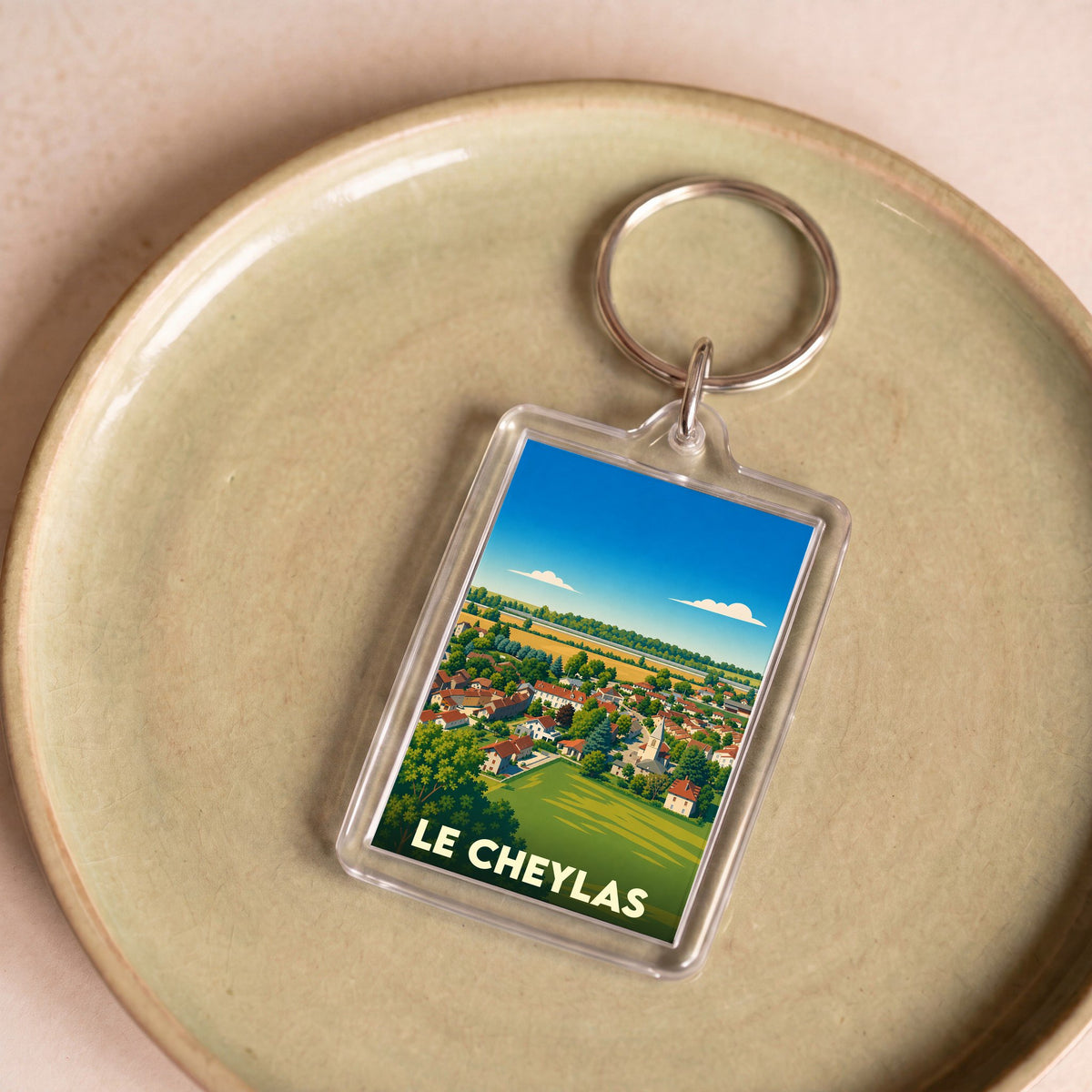 Porte-clés souvenir de la ville de Le Cheylas avec une illustration paysagère stylisée.