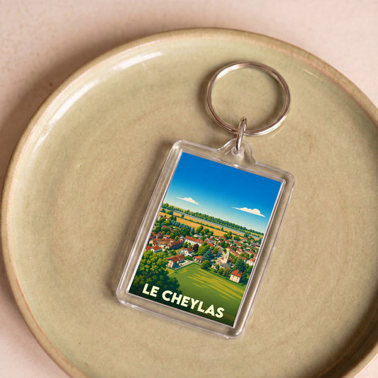 Porte-clés souvenir de la ville de Le Cheylas avec une illustration paysagère stylisée.