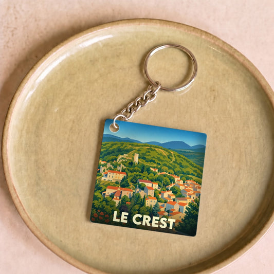 Porte-clés souvenir de la ville de Le Crest avec une illustration stylisée de ses paysages vallonnés.