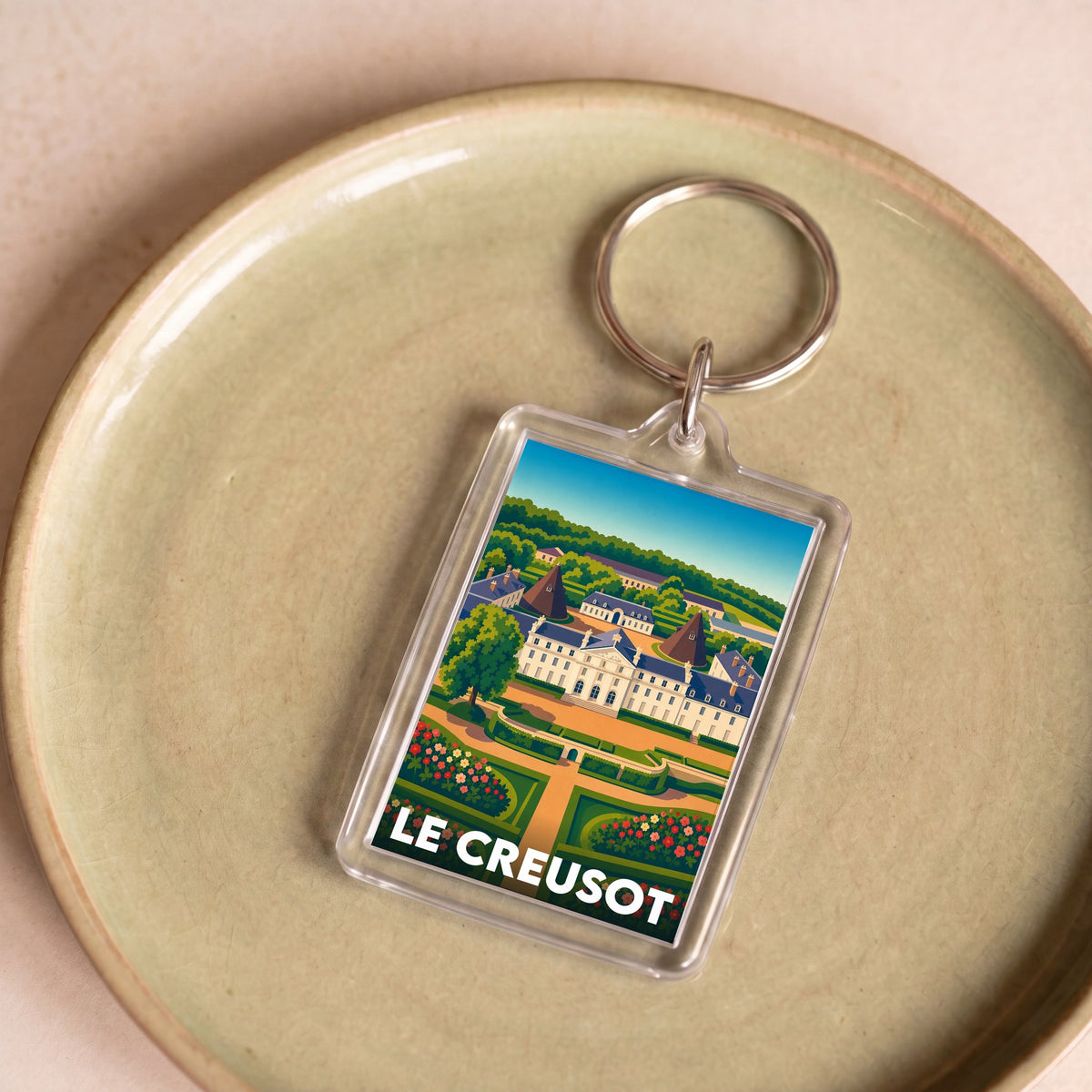 Porte-clés souvenir de la ville de Le Creusot avec une illustration stylisée.