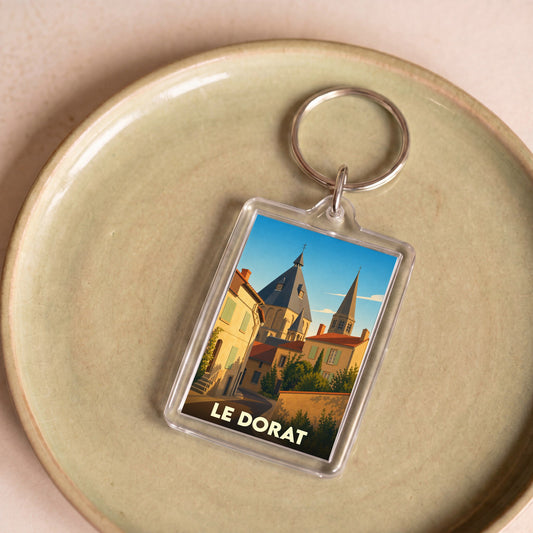 Porte-clés souvenir de la ville du Dorat avec une illustration stylisée de son église.