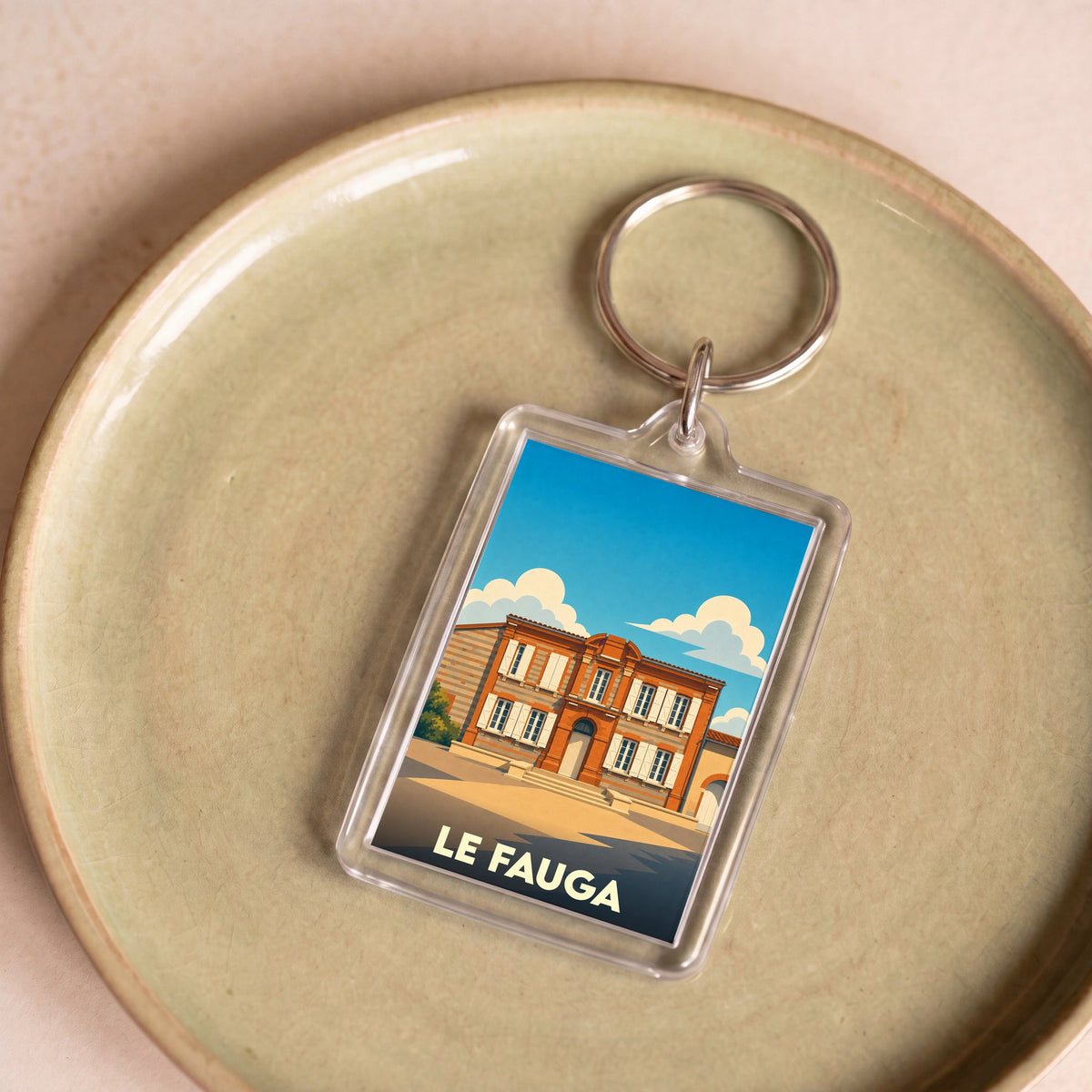 Porte-clés souvenir de la ville de Le Fauga avec une illustration stylisée de son patrimoine.