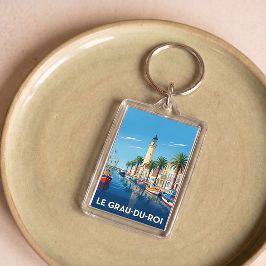 Porte-clés souvenir de la ville du Grau-du-Roi avec une illustration stylisée.