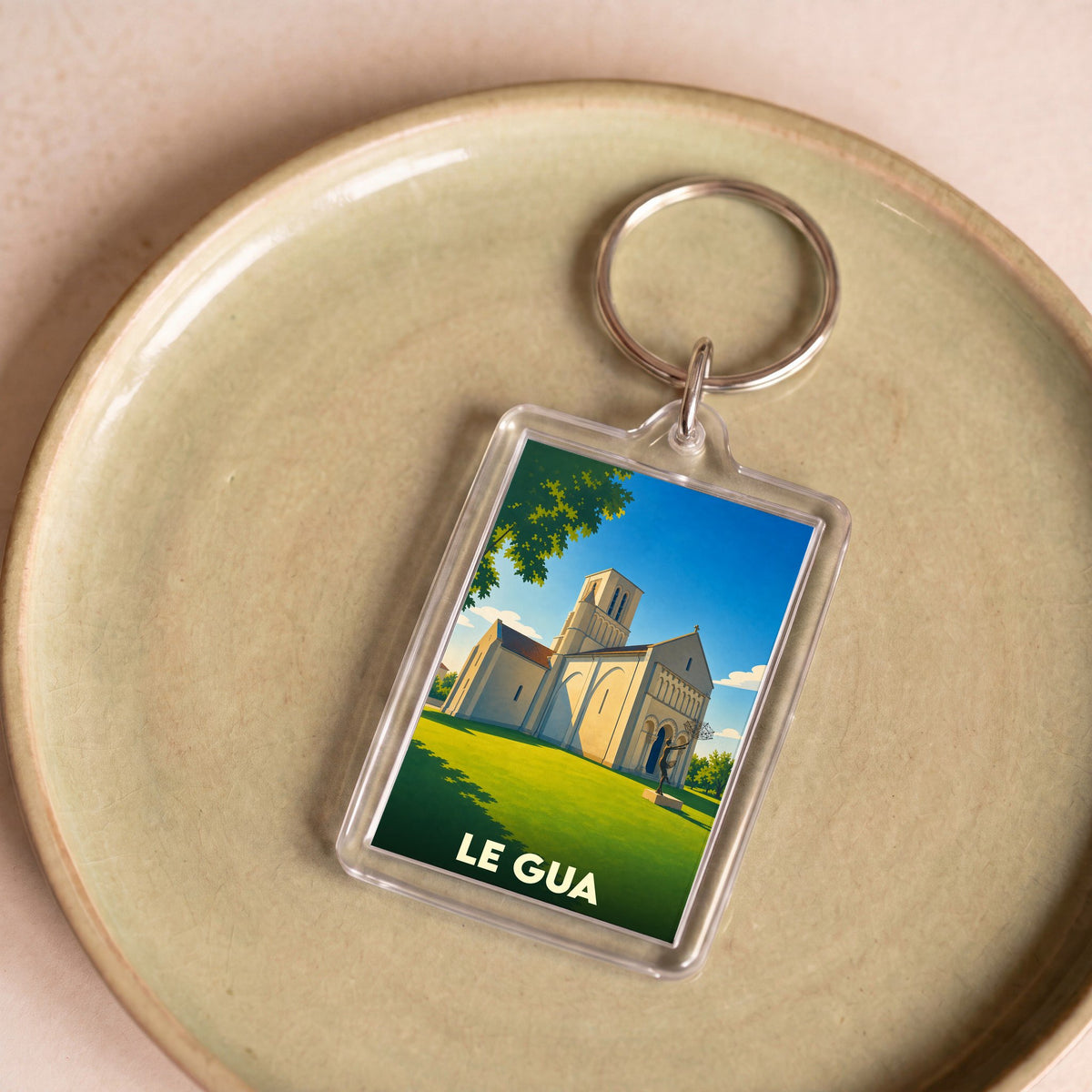 Porte-clés souvenir de la ville de Le Gua avec une illustration stylisée de son église.