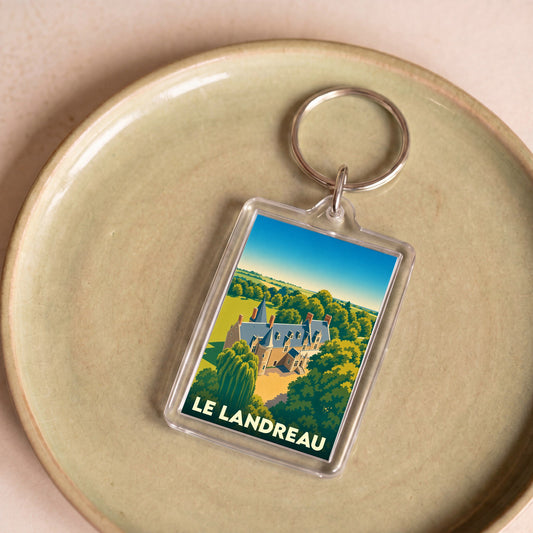 Porte-clés souvenir de la ville de Le Landreau avec une illustration stylisée.