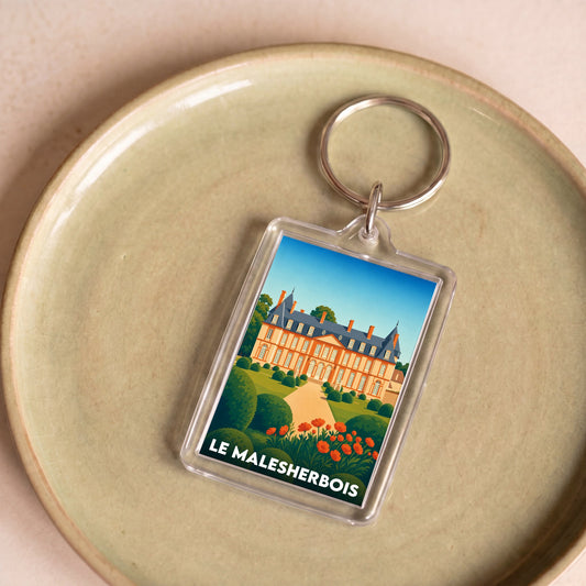 Porte-clés souvenir de la ville de Le Malesherbois avec une illustration stylisée.