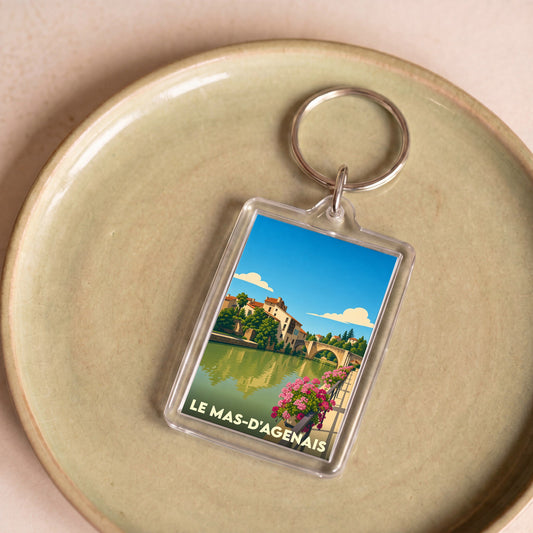Porte-clés souvenir de la ville du Mas-d'Agenais avec une illustration stylisée.