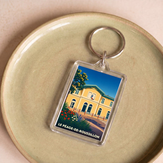 Porte-clés souvenir de la ville du Péage-de-Roussillon avec une illustration stylisée.